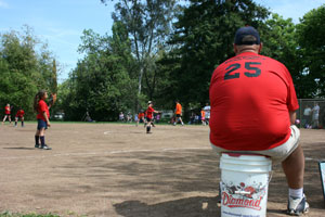 Maddie pitching (her dad's sitting on the bucket)